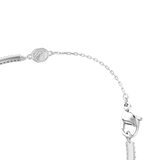 Silver-toned bracelet with a curved band featuring clear stones, a delicate chain extension, a lobster clasp, and an octagona