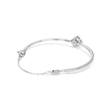 Silver-toned bangle with a green clover design. One half is lined with clear stones. Features a swan detail and chain extensi