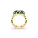 Gold-toned ring with a rectangular light green gemstone surrounded by smaller round green and dark grey gemstones in a domed