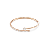 Rose gold-toned open bangle bracelet with a row of clear pavé-set crystals and a larger central clear round-cut crystal.
