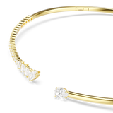 Gold-toned torc necklace. One end has an oval-cut white crystal; the other has a row of pear-cut and smaller white crystals.