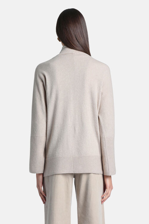 Beige open cardigan of carded wool with a stand-up collar, long sleeves with wide cuffs, and a banded hem.