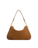 Brown faux suede crescent shoulder bag with dark brown faux leather strap and bottom corner patches, featuring gold-toned cha