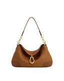 Brown faux suede shoulder bag with a dark brown strap, gold-toned chain links, and a prominent gold-toned metal pendant.
