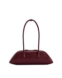 Deep claret shoulder bag with an elongated, boat-shaped body, two thin arched straps, and a gold-toned top zipper.