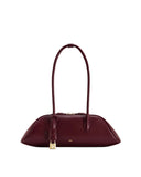 Deep claret leather shoulder bag with an elongated, structured silhouette, a single strap, gold-toned hardware, and a padlock