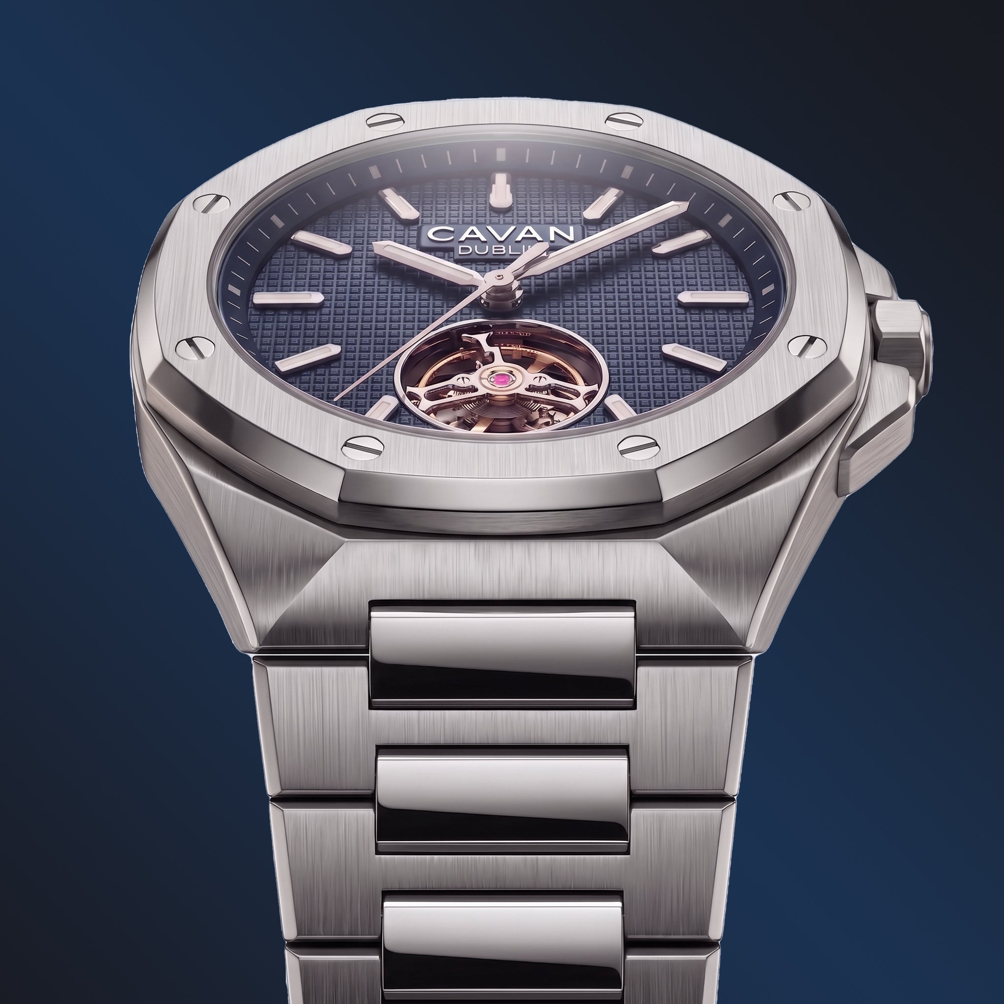 Silver-toned watch with octagonal bezel, dark blue textured dial, gold accents, open heart movement, and metal bracelet.