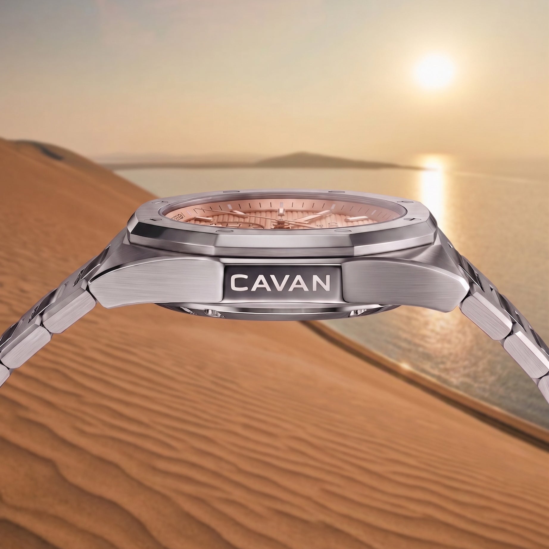 Silver-toned watch with an octagonal bezel, rose gold-toned textured dial, and a metal link bracelet. "CAVAN" is engraved on