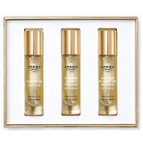 White gift set box containing three clear glass fragrance bottles with gold-toned caps and labels for Creed Aventus, Green Ir