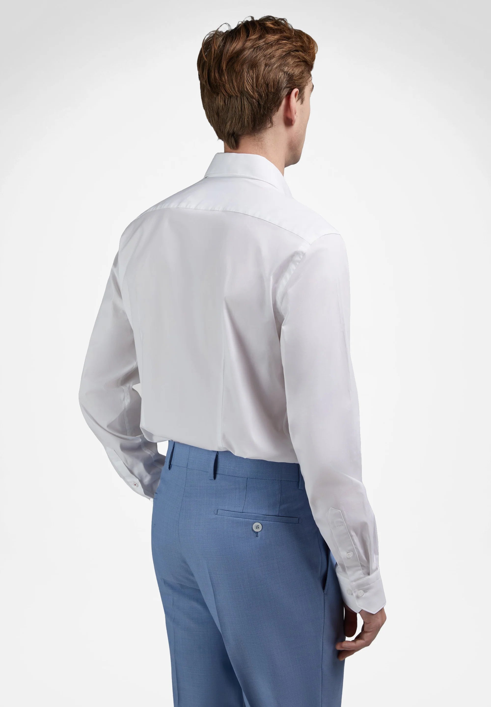 White long-sleeved dress shirt with a classic collar, back darts, and buttoned cuffs.