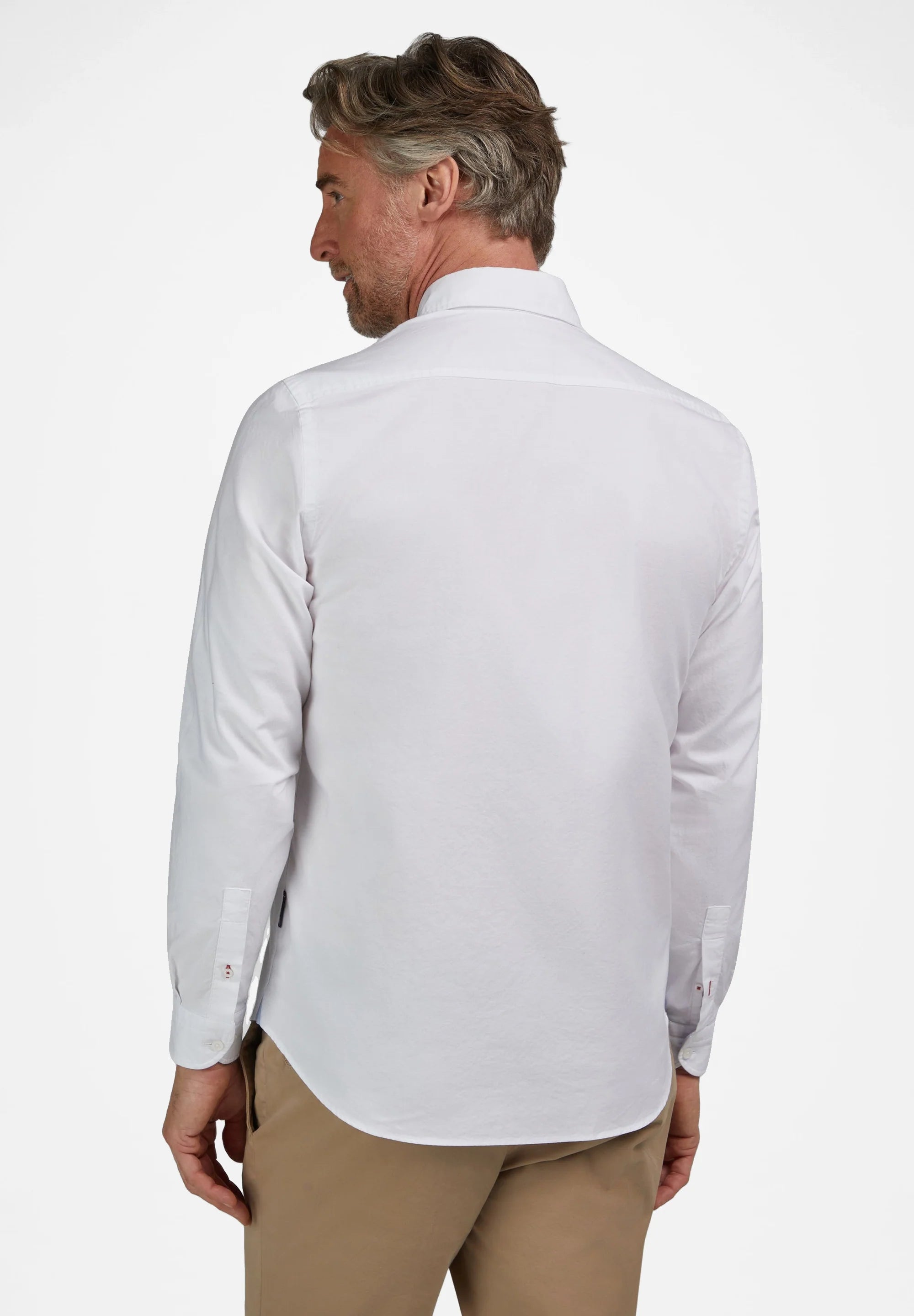 White long-sleeved shirt with a classic collar, plain back, and buttoned cuffs. Small red and blue details are visible on the