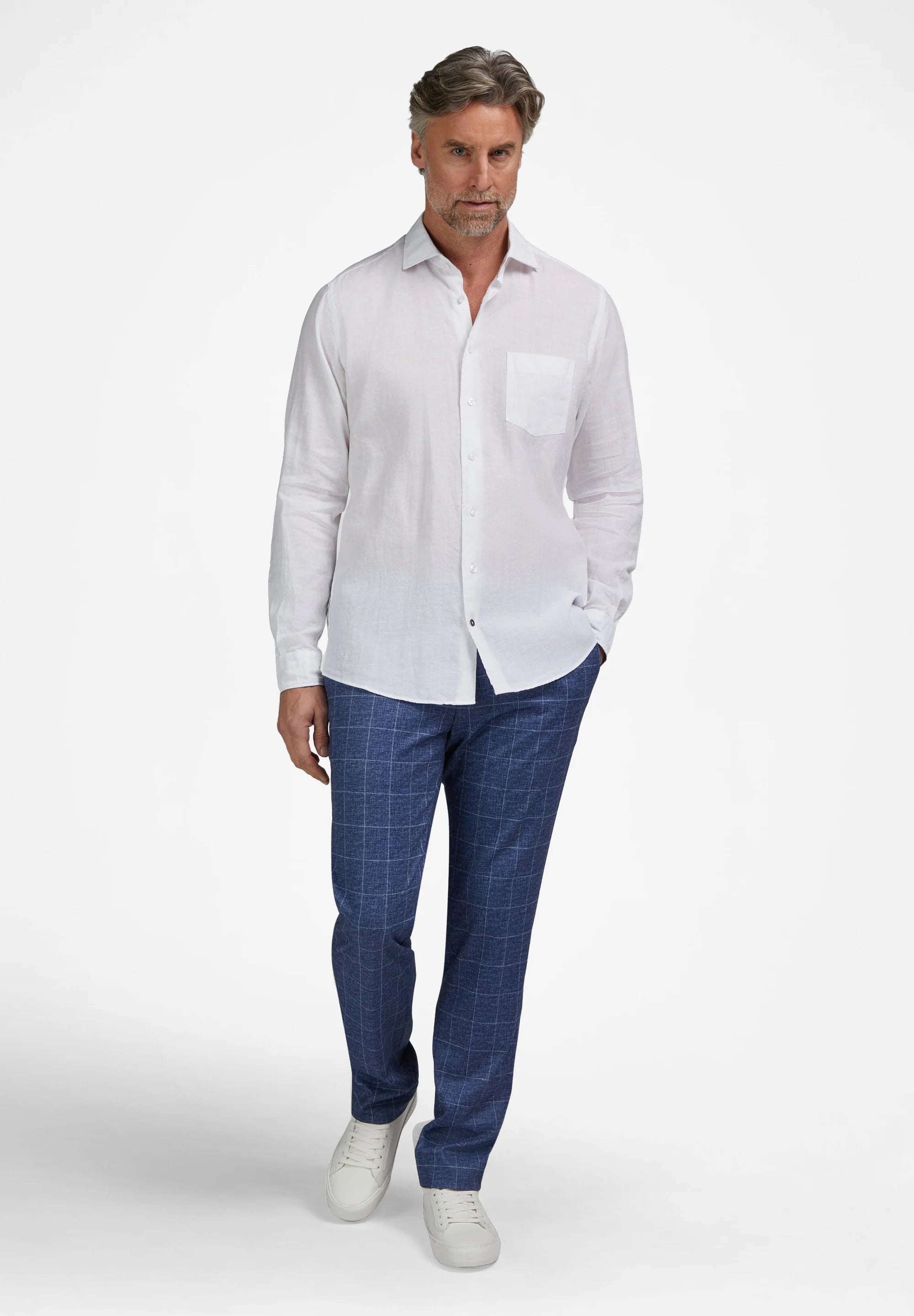 White long-sleeved collared shirt with a button-down front, a single left chest pocket, and a visible linen texture.