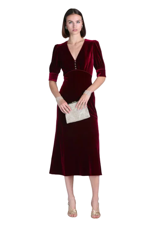 Ruby velvet midi dress with V-neckline, empire waist, puffed elbow-length sleeves, and three small buttons on the bodice.