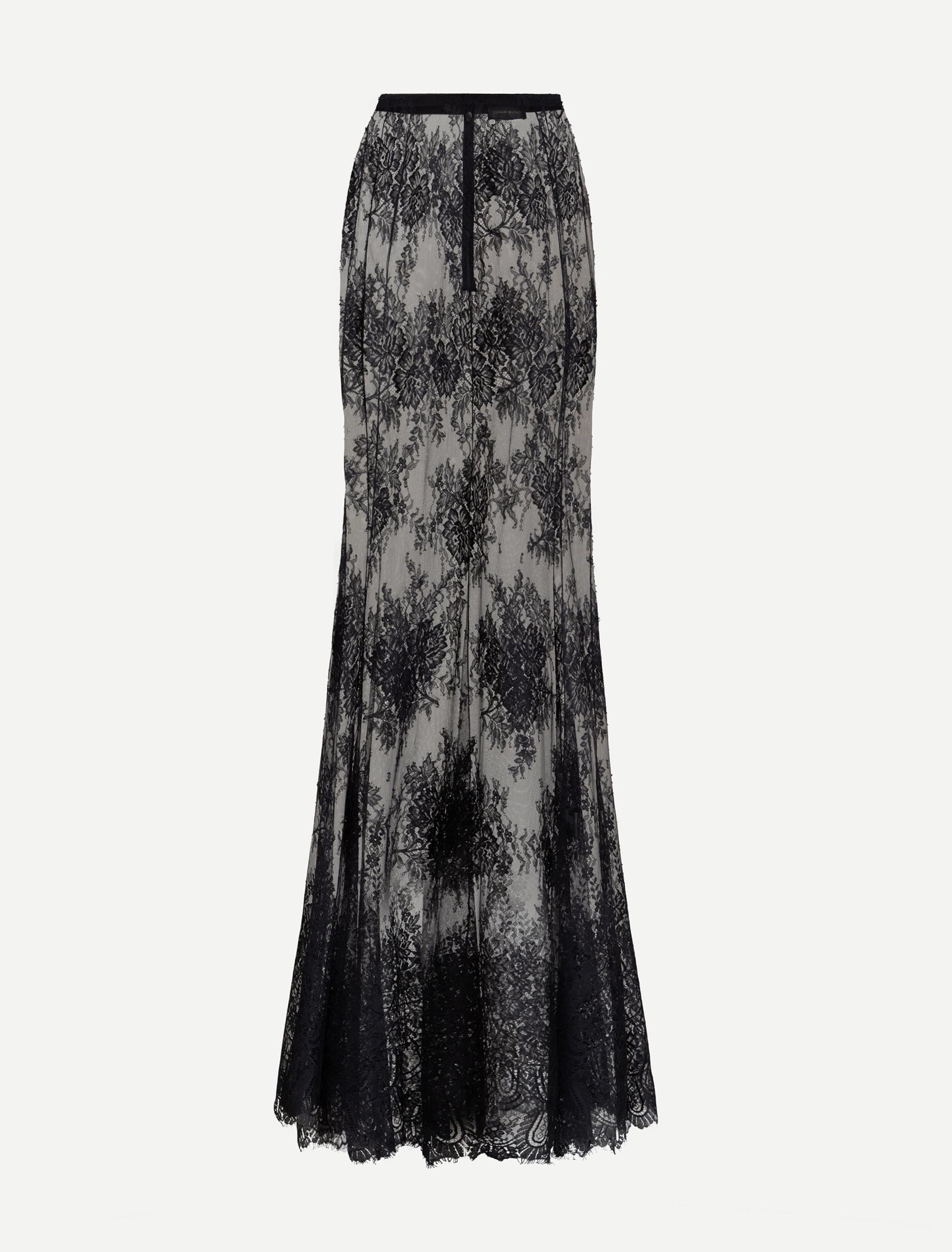 Fitted long black floral lace skirt with a light lining, elastic waistband, front zipper, and scalloped lace hem.