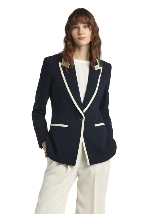 Navy blue single-breasted jacket with off-white contrasting trim on lapels and pockets, featuring a single button closure.