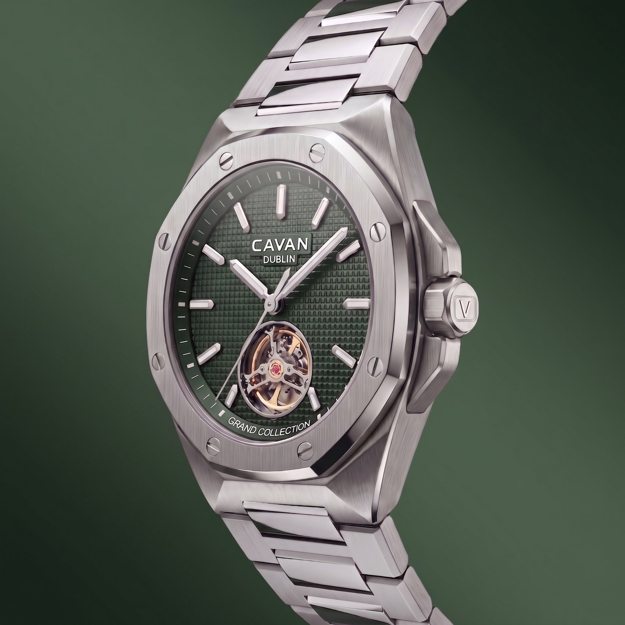 Silver-toned metal watch with an octagonal bezel, textured green dial, and an open-heart movement showing gold-toned gears an