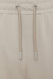 Khaki sweatpants with an elastic waistband, light khaki drawstrings with gray plastic tips, and gray metal grommets.