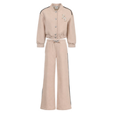 A two-piece children's tracksuit in a light beige or blush pink color, featuring a cropped button-up jacket with black shoulder stripes and a matching pair of wide-leg pants with black side stripes.