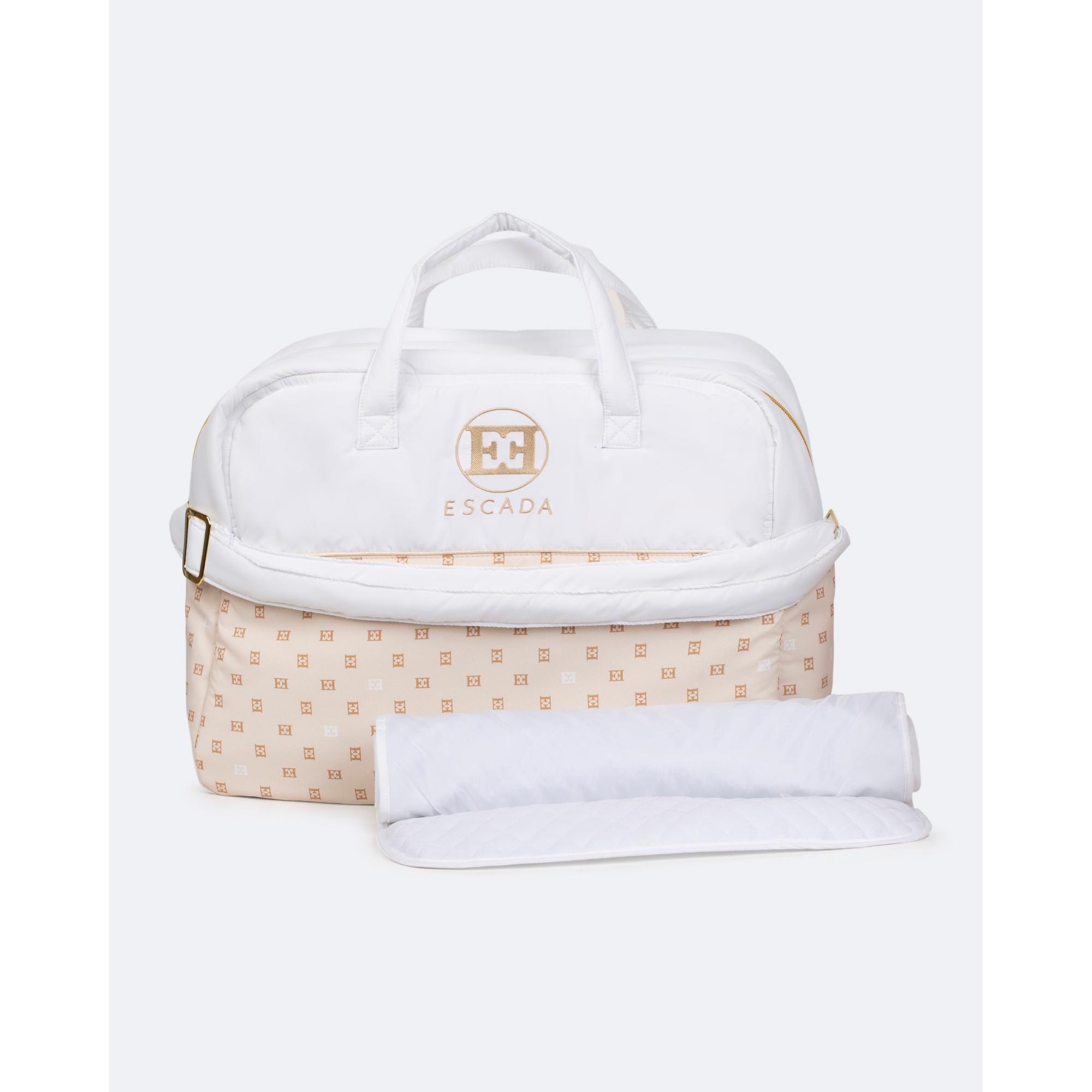 Off-white changing bag with gold-toned Escada logo, beige lower section with repeating gold-toned pattern, and a white rolled