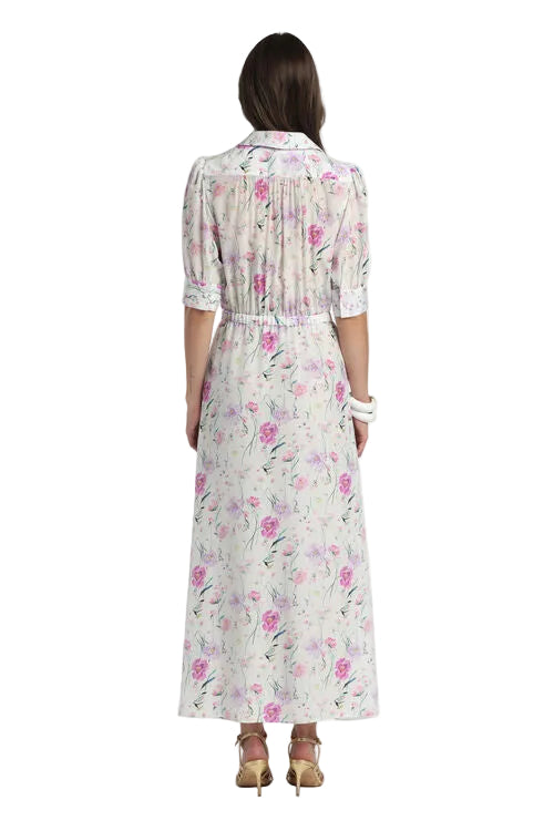 Off-white maxi dress with fuchsia and purple floral print, collared neckline, short puffed sleeves with cuffs, and a gathered
