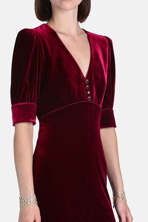 Ruby velvet dress with a V-neck, puffed elbow-length cuffed sleeves, and four dark round buttons on the bodice.