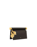 Dark brown clutch with a gold-toned cylindrical top handle and two large, textured gold-toned leaf pendants.