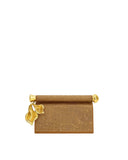 Dark brown embellished clutch bag with a fold-over top, gold-toned cylindrical bar, and two gold-toned holly leaf pendants.