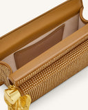 Dark brown clutch with gold-toned stud embellishments, tan trim, and a gold-toned holly pendant. Interior pocket visible.