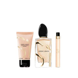Giorgio Armani Si gift set: peach body lotion tube, clear perfume bottle with black cap and gold-toned accents, and a slim pe