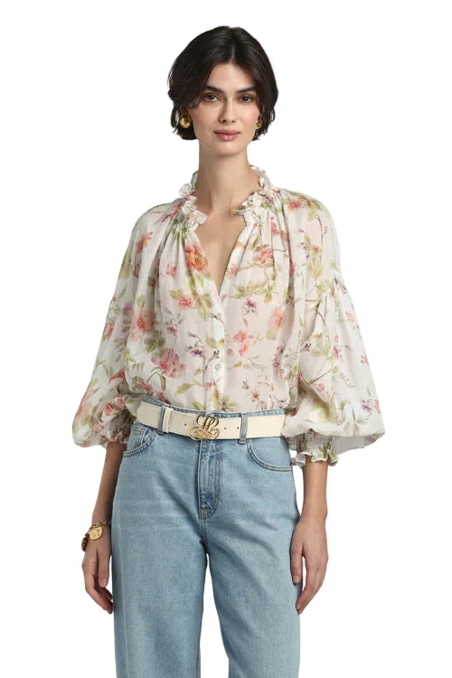 Off-white and peach floral print blouse with ruffled collar, voluminous sleeves, and elasticated ruffled cuffs.