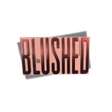 Bassam Fattouh The Blushed face palette in its metallic rose-gold casing featuring bold, embossed "BLUSHED" lettering across the front cover, from blue salon.
