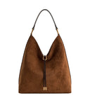 Brown faux suede shoulder bag with a slouchy shape, dark brown strap, and gold-toned hardware including a D-ring and tie deta