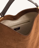 Brown faux suede shoulder bag with a dark brown strap, gold-toned hardware, magnetic snap, and a light interior with a zipper