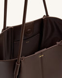 Deep brown vegan leather wide tote bag with thin straps knotted at the top, magnetic closure, and gold-toned 'JW PEI' logo.