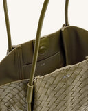 Olive green woven tote bag with smooth interior, thin handles (one stitched, one smooth), snap closure, silver-toned 'JW PEI'