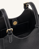 Black pebbled faux leather tote bag with white contrast stitching, two top handles, and gold-toned magnetic snap closure.