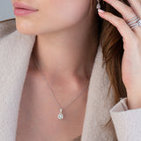 Silver-toned chain necklace with a round clear stone pendant in a four-prong setting.
