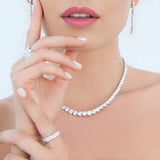 Silver-toned necklace with a single row of graduated round clear stones, individually set.