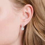 Silver-toned leverback earring with a large round clear stone and smaller clear stones set along the tapered top.