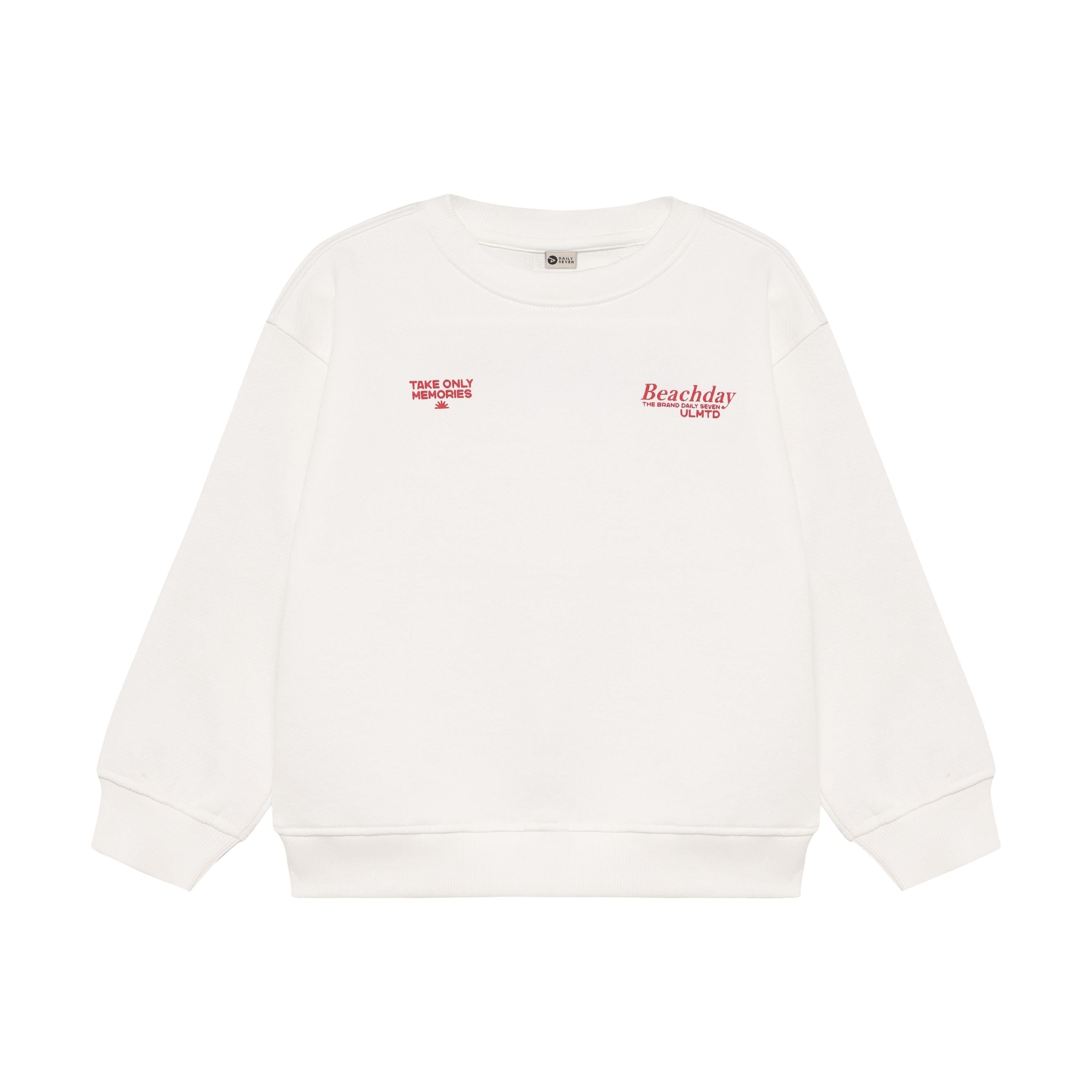 Off-white oversized crew neck sweater with red "TAKE ONLY MEMORIES" and "Beachday" graphic prints on the chest.