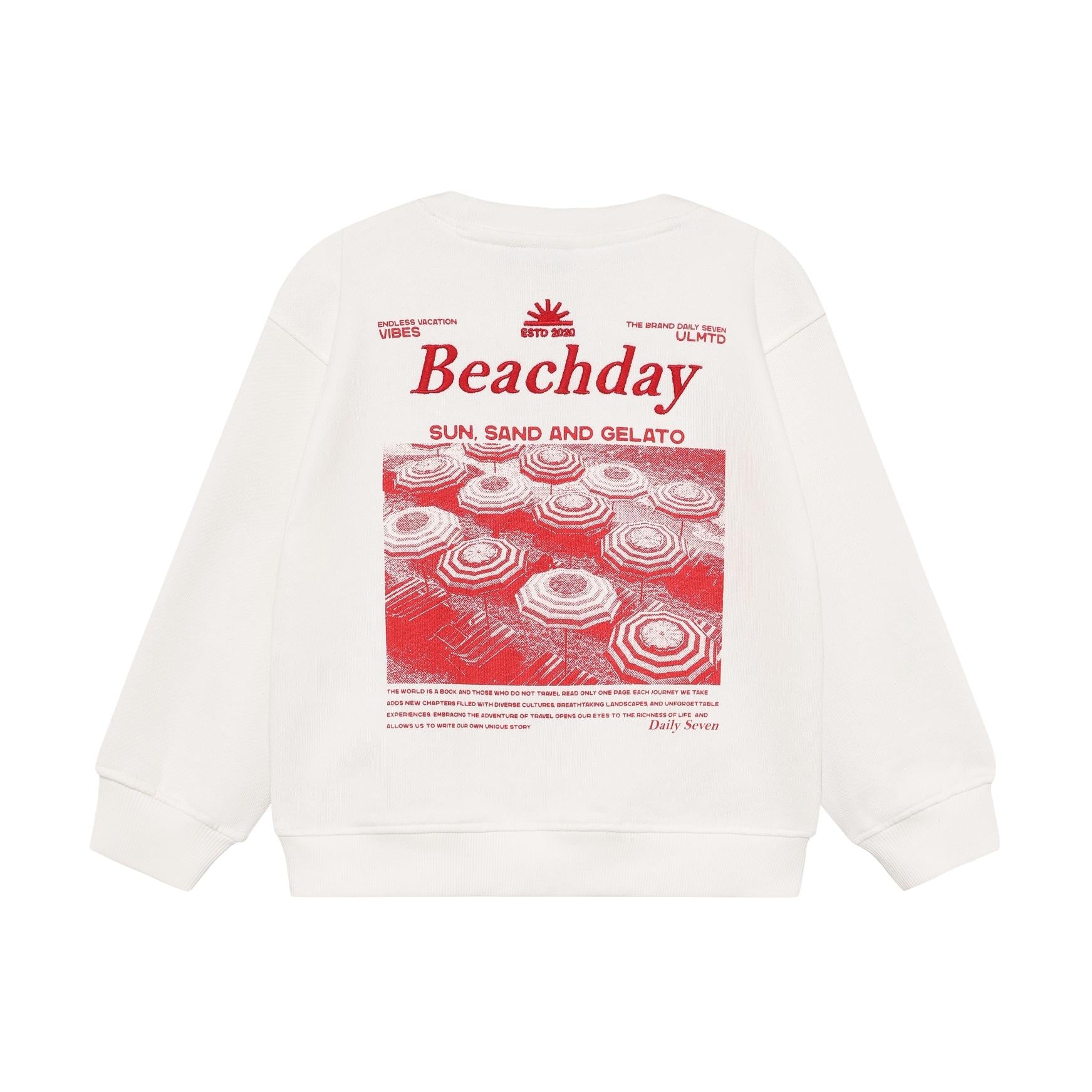 White oversized crew neck sweater with ribbed cuffs and hem, featuring a large red graphic print on the back with 'Beachday',
