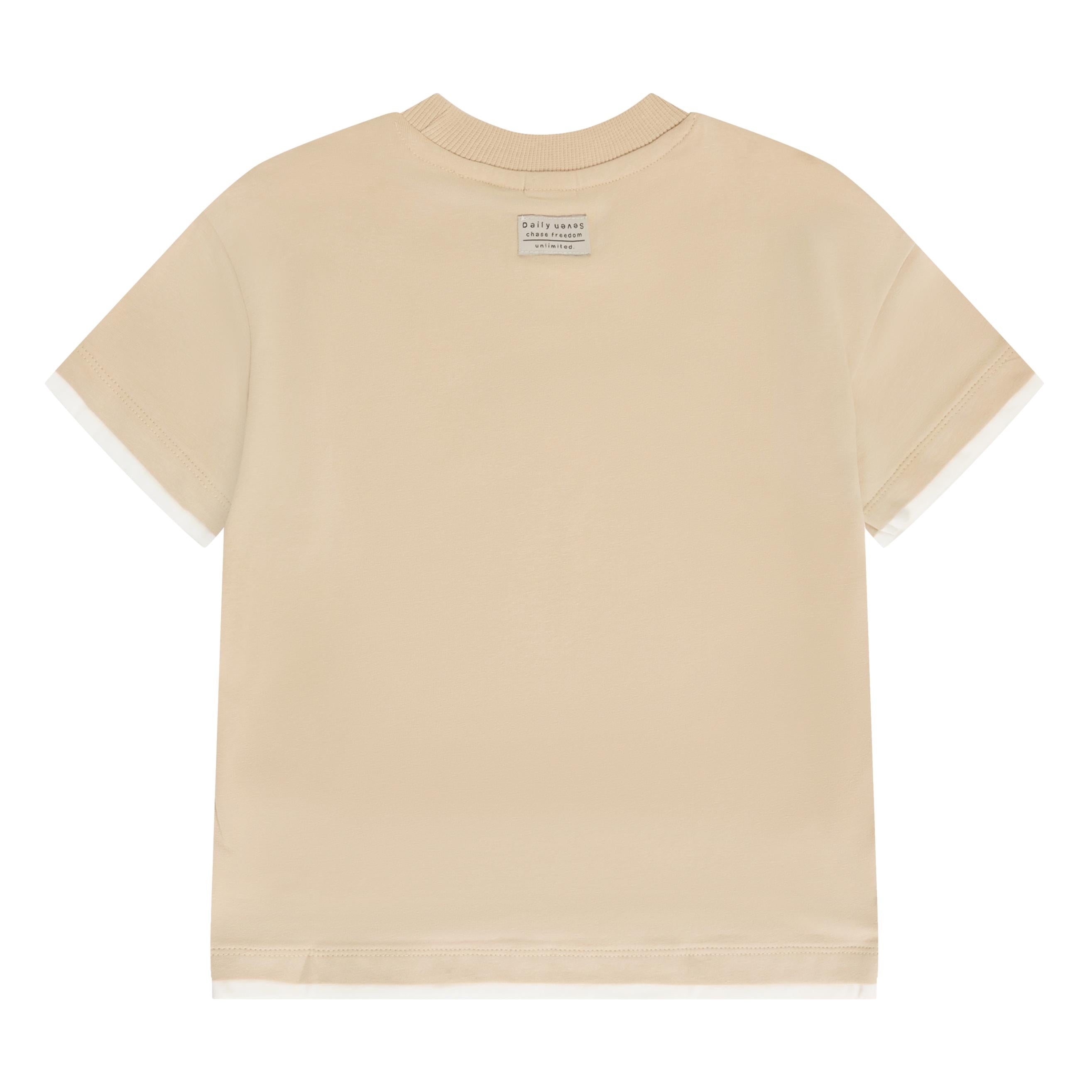 Beige oversized t-shirt, back view. Ribbed crew neck, short sleeves with white layered cuffs, and a white layered hem. Small