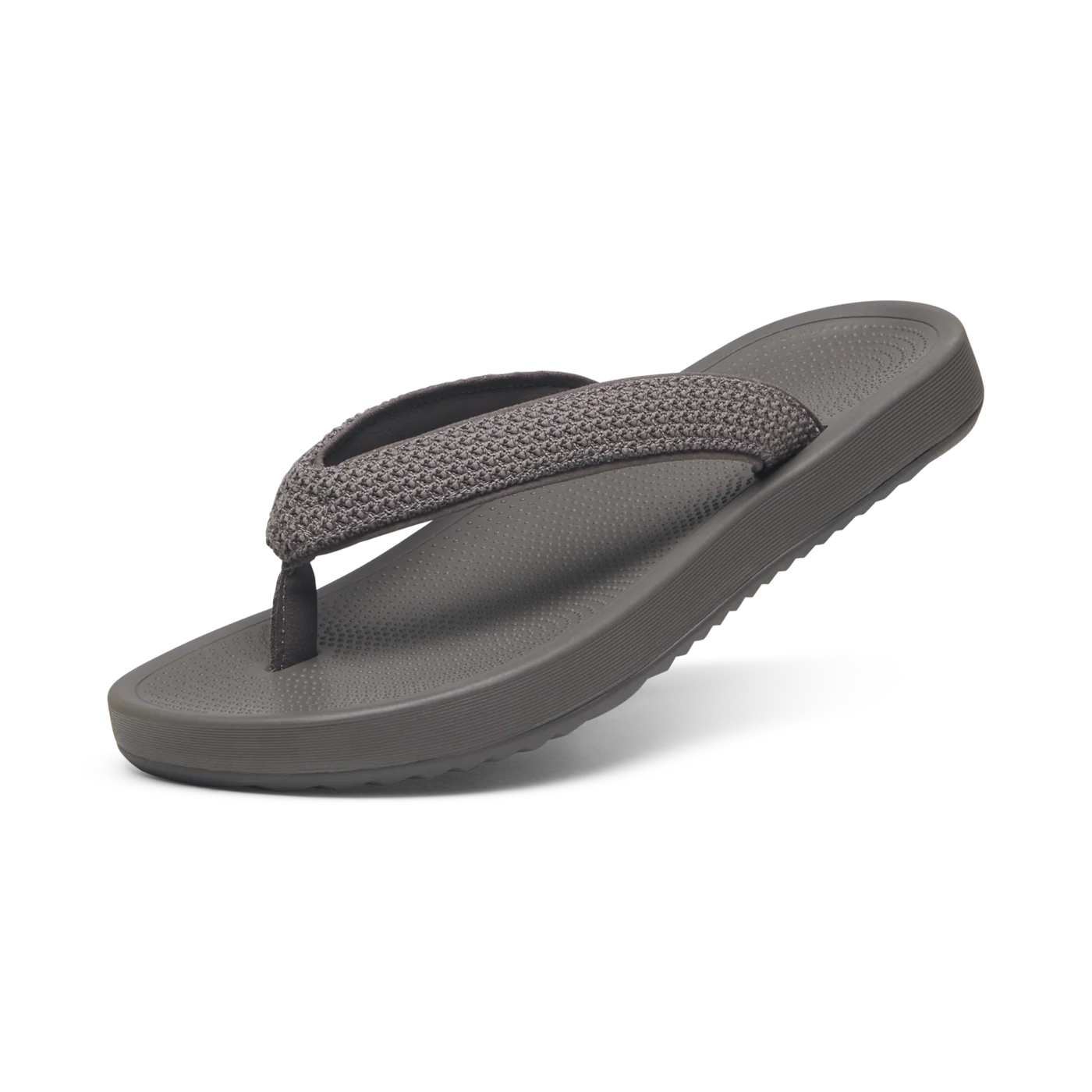 Grey flip-flop with a textured knit strap and a smooth grey sole with a dotted footbed.