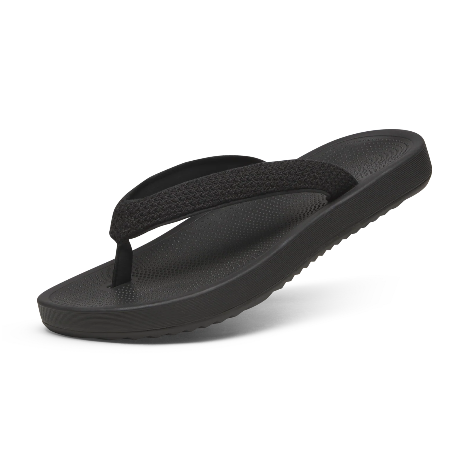 Single black flip-flop with textured straps and footbed, featuring a thick platform sole with ridged sides.