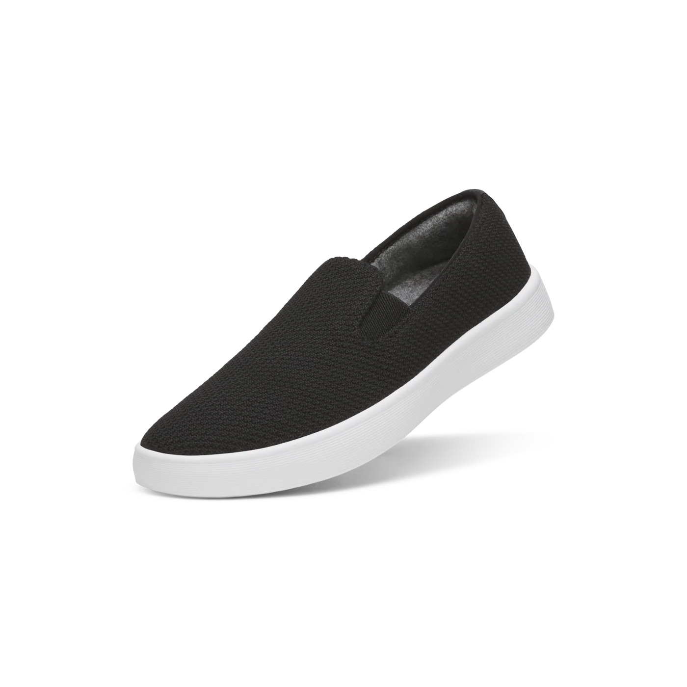 Black knit slip-on shoe with a white sole and visible grey lining.