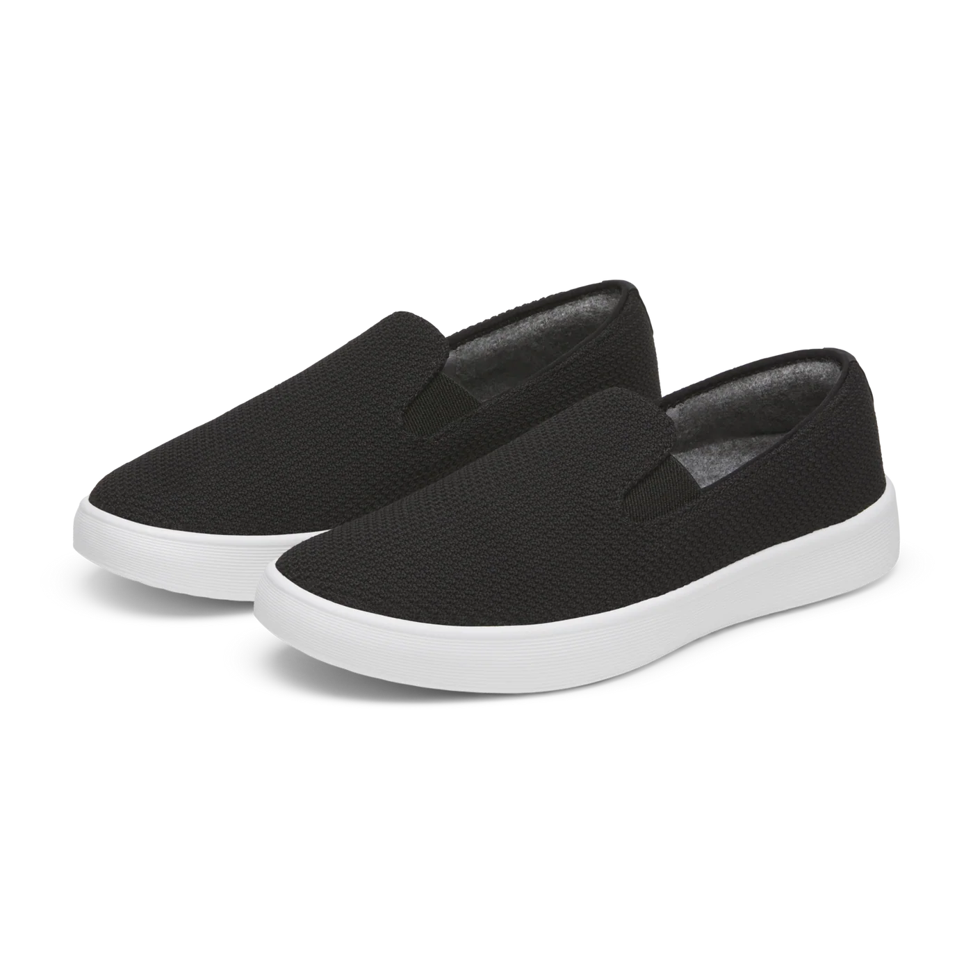 Black knitted slip-on shoes with white soles.