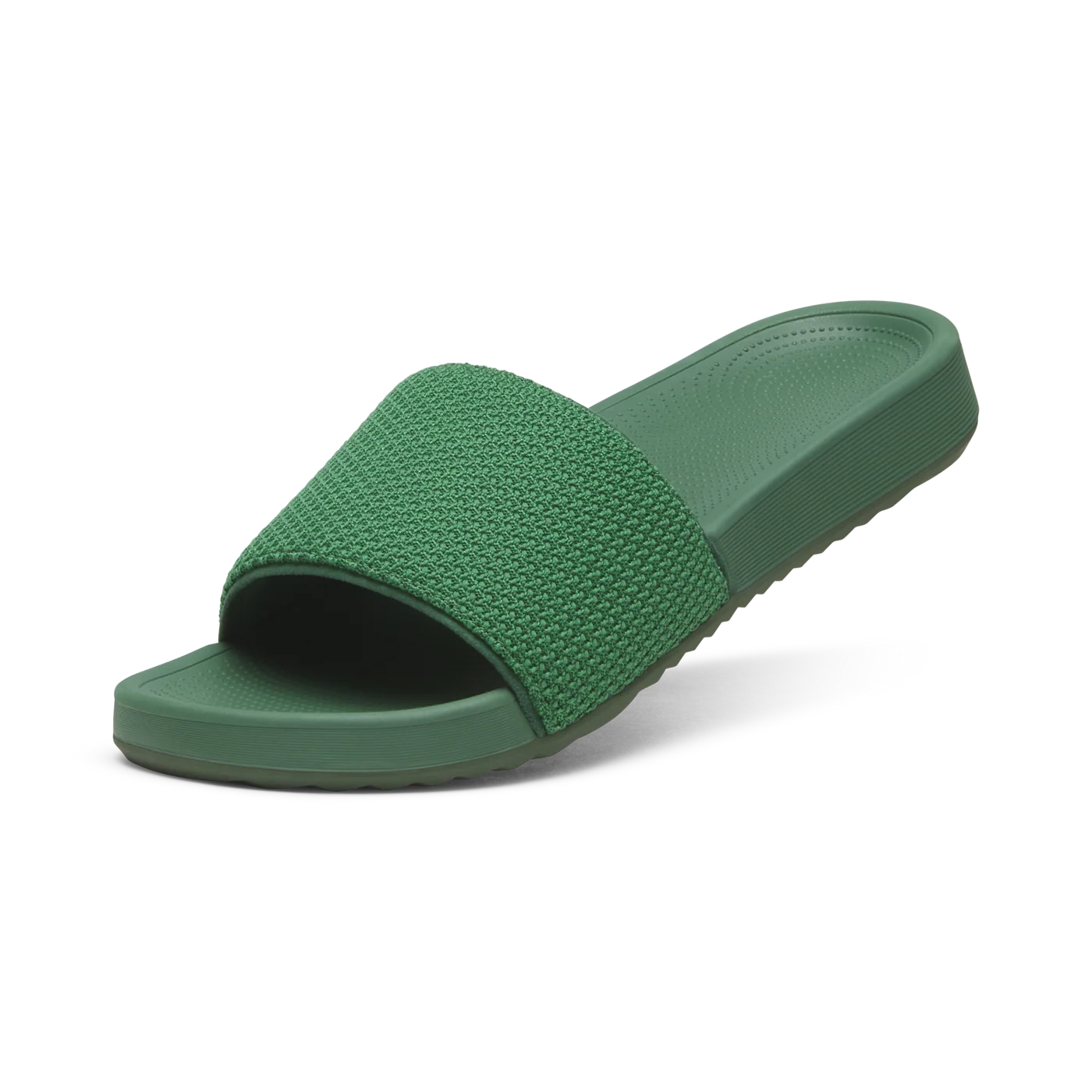 Green slide sandal with a wide, textured knit upper strap and a monochromatic molded sole. The footbed has a subtle pattern.