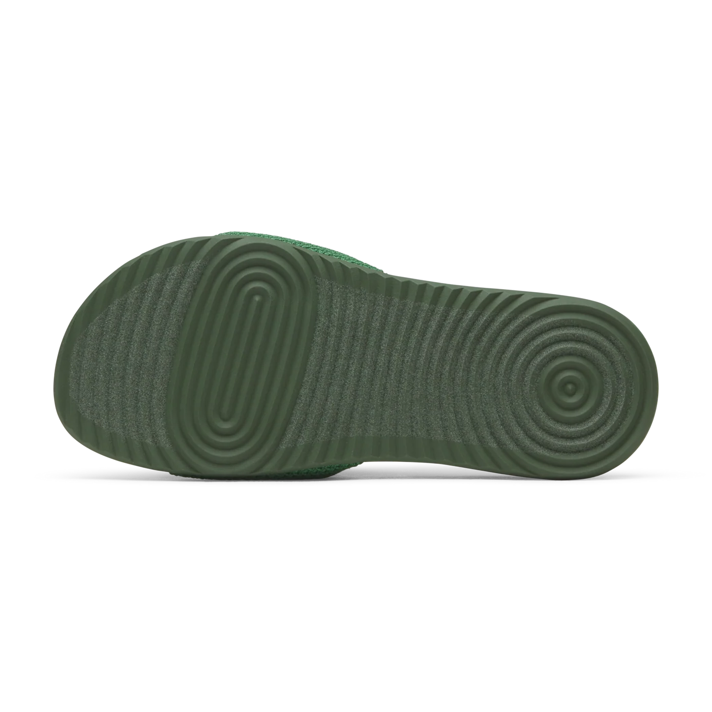 Green slide sandal, bottom view. Dark green sole with concentric oval and circular grip patterns. Textured green strap.