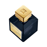 Square dark blue glass perfume bottle with a gold-toned square cap featuring an MFK logo and a gold-toned label.