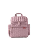 Mauve mist quilted backpack with chevron pattern, top handle, multiple zippered pockets, and gold-toned hardware.